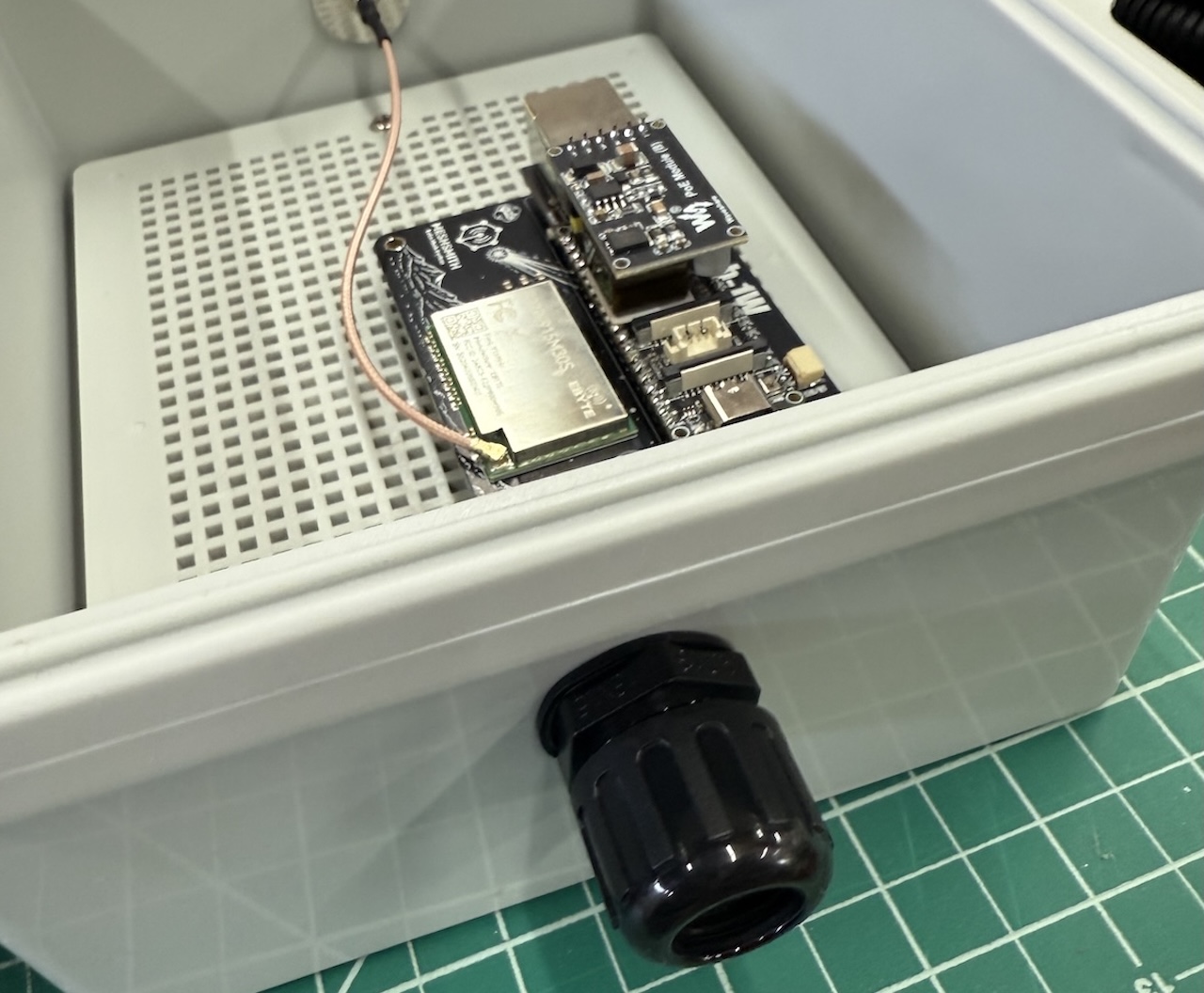 Gland installed in the enclosure without conduit, showing the ethermesh in the background.